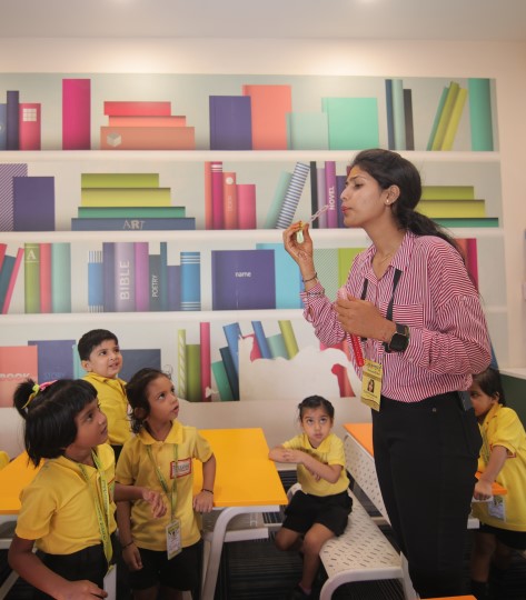 Kids and teacher having fun learning activities at Crayons Montessori Play School Ranchi