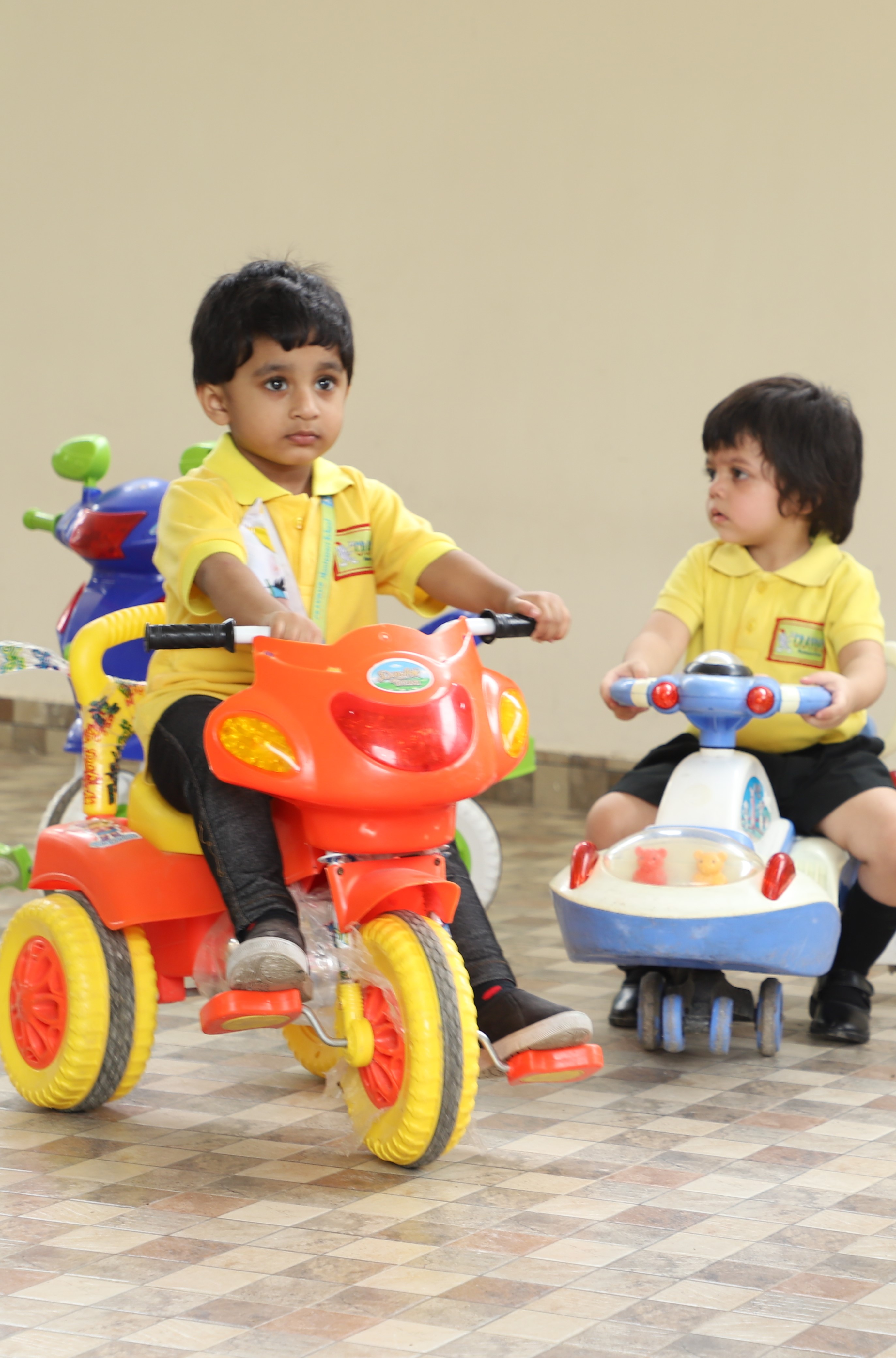 Kids riding Bike and playing toys at Crayons Montessori Play School, the best Play School in Ranchi| Kanke Road | Day Care